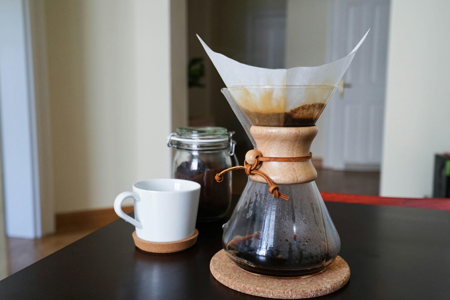 coffee on a dark table with a glass beside it